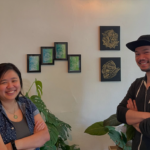 Image of Lilly and Samson in front of artwork at Apa Kabar
